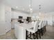 Bright kitchen with white cabinetry, stainless steel appliances, and a spacious island with seating at 10820 Tarflower Dr # 202, Venice, FL 34293