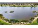 Expansive lake view showcasing the tranquil waters and lush landscaping of the surrounding community at 10820 Tarflower Dr # 202, Venice, FL 34293
