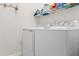 Well-lit laundry room with a front-load washer and dryer at 10820 Tarflower Dr # 202, Venice, FL 34293