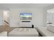 Bright living room boasts white decor, modern entertainment center, and an open staircase at 10820 Tarflower Dr # 202, Venice, FL 34293