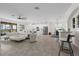 Spacious open-concept living room with tile floors, modern furnishings, and scenic views at 10820 Tarflower Dr # 202, Venice, FL 34293