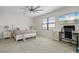 Spacious main bedroom features a large window, a ceiling fan, and an adjacent computer desk at 10820 Tarflower Dr # 202, Venice, FL 34293