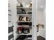 Organized pantry shelves stocked with kitchen appliances, cookware, and other household items at 10820 Tarflower Dr # 202, Venice, FL 34293