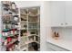 Walk-in pantry with wire shelving stocked with an assortment of cookware and ingredients at 10820 Tarflower Dr # 202, Venice, FL 34293