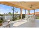 Enjoy amazing water views from this spacious screened-in lanai, furnished with comfortable seating and dining at 10820 Tarflower Dr # 202, Venice, FL 34293