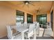 Relaxing screened patio with white table and chairs, perfect for outdoor dining and enjoying the fresh air at 10820 Tarflower Dr # 202, Venice, FL 34293