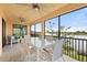 Delightful screened patio overlooking the lake, featuring a dining table and comfortable seating at 10820 Tarflower Dr # 202, Venice, FL 34293