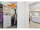 Walk-in closet with built-in shelving and clothing racks, with an adjacent ensuite bathroom at 10820 Tarflower Dr # 202, Venice, FL 34293