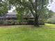 Lush backyard featuring a screened-in pool area and mature shade trees at 1212 Candlewood Dr, Lakeland, FL 33813
