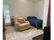 A simple bedroom furnished with a recliner, twin bed, and closet space at 1212 Candlewood Dr, Lakeland, FL 33813