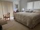 Cozy bedroom featuring a large bed, neutral decor, and natural light from a sliding glass door at 1212 Candlewood Dr, Lakeland, FL 33813