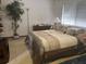 Comfortable bedroom with a queen bed, dresser, soft lighting and ample sunlight from the window at 1212 Candlewood Dr, Lakeland, FL 33813