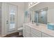 Bright bathroom features a modern vanity with white marble countertop and access to a patio at 13115 Harriers Pl, Bradenton, FL 34212