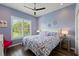 Charming bedroom with purple accent wall, hardwood floors, large window and modern accents at 13115 Harriers Pl, Bradenton, FL 34212