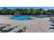 Community pool with zero entry, splash features, and ample lounge seating at 13115 Harriers Pl, Bradenton, FL 34212