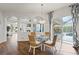 Dining room with glass table, elegant chandelier and views of the screened-in pool area at 13115 Harriers Pl, Bradenton, FL 34212