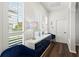 Hallway with lovely blue accents, a white accent table, and plantation shutters at 13115 Harriers Pl, Bradenton, FL 34212