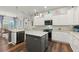 Modern kitchen with granite countertops, stainless steel appliances, and a center island at 13115 Harriers Pl, Bradenton, FL 34212