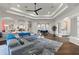 Spacious living room with hardwood floors, tray ceilings, and modern furnishings for a luxurious home feel at 13115 Harriers Pl, Bradenton, FL 34212