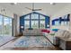 Spacious living room featuring vaulted ceilings, a large sofa, and a sliding glass door at 13115 Harriers Pl, Bradenton, FL 34212