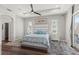 Serene bedroom with a king-size bed, a ceiling fan, and large windows at 13115 Harriers Pl, Bradenton, FL 34212