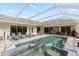Enjoy this fabulous screened in pool with hot tub, fountain and outdoor lounge area at 13115 Harriers Pl, Bradenton, FL 34212