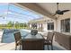 Outdoor space with covered patio, screened-in pool, dining table, and lounge chairs for relaxing by the water at 13115 Harriers Pl, Bradenton, FL 34212