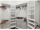 Organized walk-in closet with shelves and hanging rods for ample storage at 13115 Harriers Pl, Bradenton, FL 34212