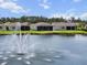 Beautiful homes with landscaped yards bordering a serene lake with a central fountain at 13915 Mount Laurel Trl, Bradenton, FL 34211