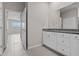 Open bathroom view of dual sink vanity and open doorway into bedroom at 13915 Mount Laurel Trl, Bradenton, FL 34211