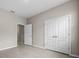 A bright bedroom with tiled floors features a closet and an entry door at 13915 Mount Laurel Trl, Bradenton, FL 34211