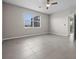 Spacious bedroom featuring tile flooring, large window and ceiling fan at 13915 Mount Laurel Trl, Bradenton, FL 34211
