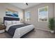 Tastefully decorated bedroom with tufted headboard, stylish bedding, contemporary art, and lots of natural light at 13915 Mount Laurel Trl, Bradenton, FL 34211