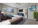 Modern bedroom showcasing art, dresser, plush bed, and ceiling fan at 13915 Mount Laurel Trl, Bradenton, FL 34211