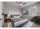 Bedroom suite with mounted TV, accent wall, stylish decor, and large window for ample natural light at 13915 Mount Laurel Trl, Bradenton, FL 34211