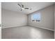 Bright, empty bedroom with neutral walls, tile floors, and a large window at 13915 Mount Laurel Trl, Bradenton, FL 34211