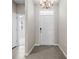 Bright entryway featuring a modern chandelier and neutral tones providing an inviting ambiance at 13915 Mount Laurel Trl, Bradenton, FL 34211