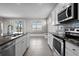 Modern kitchen features stainless appliances, granite countertops, and a breakfast nook with built-in seating at 13915 Mount Laurel Trl, Bradenton, FL 34211