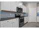 Modern kitchen featuring stainless steel appliances, granite countertops, and sleek backsplash at 13915 Mount Laurel Trl, Bradenton, FL 34211