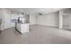 Open-concept living space with tile floors, a kitchen island, and ample natural light at 13915 Mount Laurel Trl, Bradenton, FL 34211
