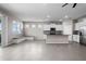 Open-concept living area featuring tile floors, a built-in bench, kitchen, and a view of the lake at 13915 Mount Laurel Trl, Bradenton, FL 34211
