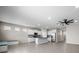 Bright living room with tile floor, a kitchen, and a ceiling fan at 13915 Mount Laurel Trl, Bradenton, FL 34211