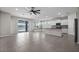 Bright open-plan living area featuring tile floors, large windows, and a modern kitchen at 13915 Mount Laurel Trl, Bradenton, FL 34211