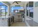 Outdoor kitchen has a grill, mini fridge, granite countertop and is covered at 13915 Mount Laurel Trl, Bradenton, FL 34211