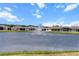 Scenic view of a community pond with a fountain and well-maintained homes in the background at 13915 Mount Laurel Trl, Bradenton, FL 34211