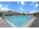 Community pool with lounge chairs and palm trees, perfect for relaxing and enjoying the Florida sunshine at 13915 Mount Laurel Trl, Bradenton, FL 34211