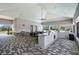 Outdoor poolside bar and seating area with a granite countertop and ample space for entertaining at 13915 Mount Laurel Trl, Bradenton, FL 34211