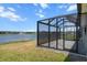 Screened-in lanai with a view of the lake and fountain at 13915 Mount Laurel Trl, Bradenton, FL 34211