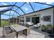 A spacious screened patio has an outdoor dining set and a lounge area at 13915 Mount Laurel Trl, Bradenton, FL 34211