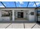 A partially covered screened patio has a kitchen and an open seating area at 13915 Mount Laurel Trl, Bradenton, FL 34211